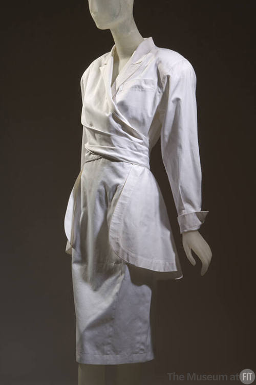 White cotton long sleeve jacket with lapels, wrap waist and peplum and matching slim skirt