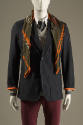 Navy blue pinstripe one button jacket with patch pockets, green silk scarf and red pants 
