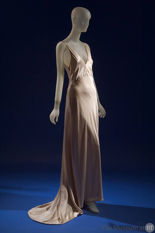 Sleeveless beige silk slip style floor length evening dress with train 