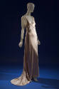 Sleeveless beige silk slip style floor length evening dress with train 
