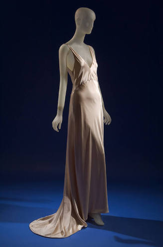 Sleeveless beige silk slip style floor length evening dress with train 