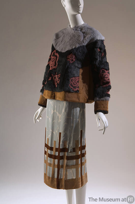 Grey, black and yellow rabbit fur jacket with red roses;  blue wrap skirt with floral print  wi…