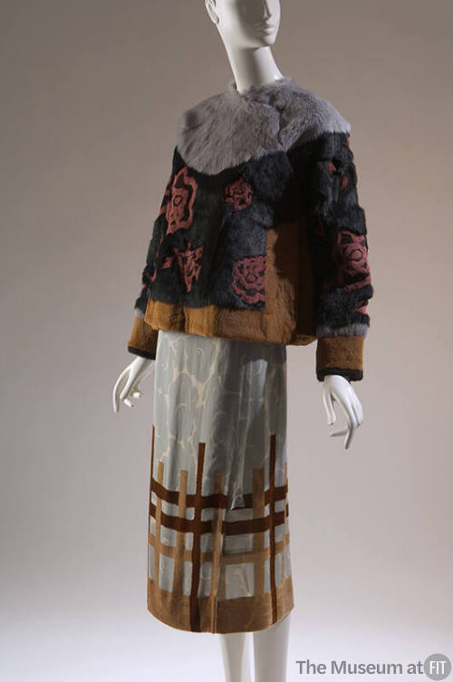 Grey, black and yellow rabbit fur jacket with red roses;  blue wrap skirt with floral print  wi…