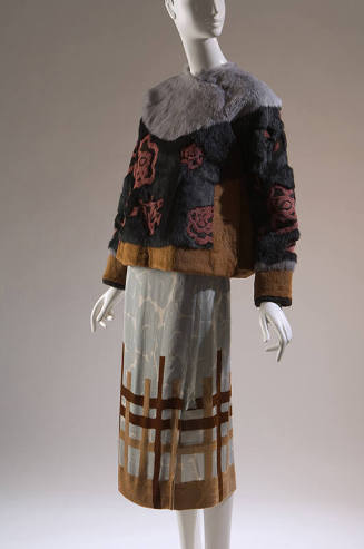 Grey, black and yellow rabbit fur jacket with red roses;  blue wrap skirt with floral print  wi…