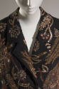 Detail of black coat notched lapels with metallic gold and red thread embroidery