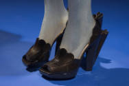 Black leather high heel open toe shoes with cutaway sides and scalloped details 