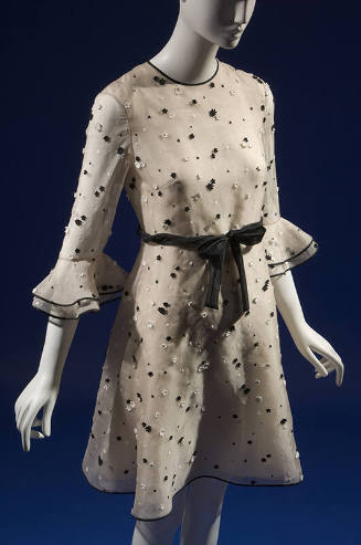 Beige silk dress with black and white daisy appliqués overall, round neckline, 3/4 sleeves with…