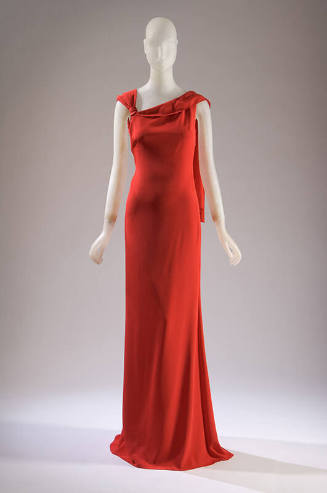 Red sleeveless silk evening dress with knotted and draped shoulder, floor length with train