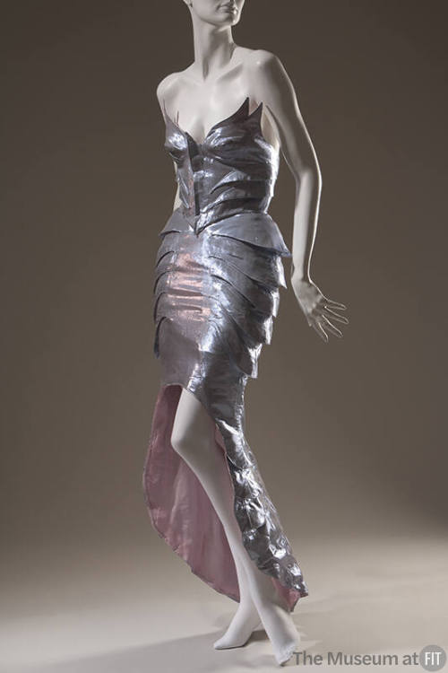 Metallic silver polyester winged bustier and high / low skirt with fish scale-like side layers …