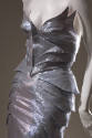 Front detail of metallic silver winged bustier and skirt with fish scale-like side layers
