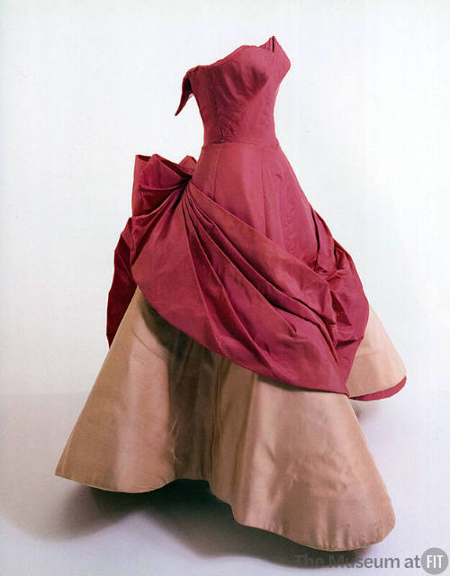 Shocking pink strapless ballgown with fitted bodice, draped pleated panel extending from back t…