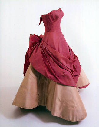 Shocking pink strapless ballgown with fitted bodice, draped pleated panel extending from back t…