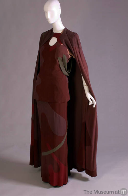 Red/brown evening ensemble of floor length cape, top with keyhole neck and matching floor lengt…
