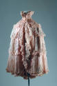 Pink evening cape with wide beaded collar and tiers of pleated ruffles edged with ruching and a…