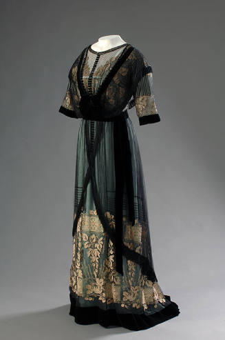 Aqua floor length dress with short sleeve black net overbodice with cream floral embroidery on …