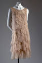 Pale pink chiffon below-the-knee length sleeveless evening dress made of graduating scalloped d…