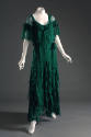 Green silk chiffon evening dress with floor length uneven hemline in allover self-ruffles, wais…