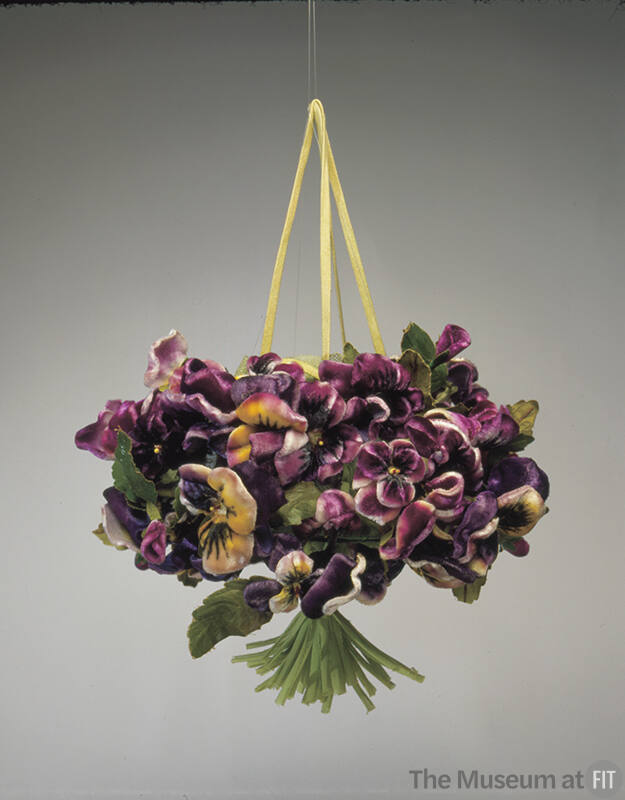 Bag in the shape of a bouquet of purple, yellow and white pansy flowers with gathered green ste…