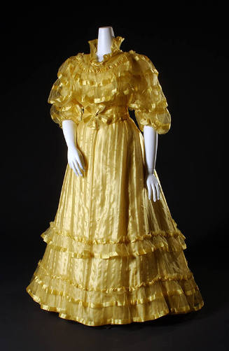 Yellow two-piece dress with horizontal yellow stripes across bodice with ¾ puffed sleeves and f…