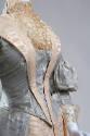 Detail view of aqua blue dress bodice showing V-shape ivory silk moiré trim and ivory net on hi…
