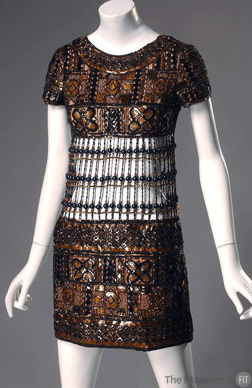 Brown short sleeve mini evening dress with geometric plaques in black, brown and ochre outlined…