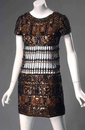 Brown short sleeve mini evening dress with geometric plaques in black, brown and ochre outlined…