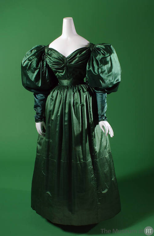 Green satin floor length dress with oversize puffed sleeves, sweetheart neckline, fitted waist …