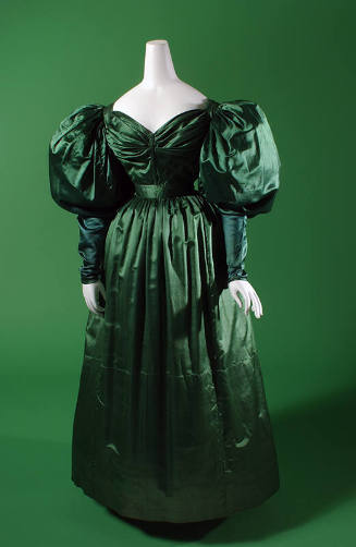 Green satin floor length dress with oversize puffed sleeves, sweetheart neckline, fitted waist …