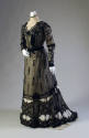 Black lace long sleeve floor-length dress with high off-white lace collar, velvet and beaded tr…