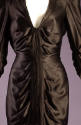 Detail of black satin dress with deep v-neck, tucks and pleats at front bodice 