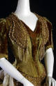 Detail of green velvet and silk ballgown V-neck bodice with pearl, rhinestone, and metallic emb…