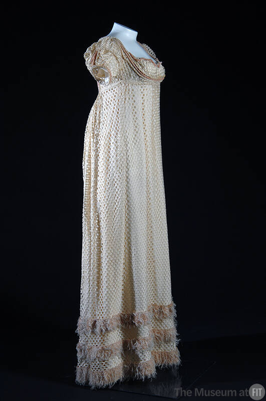 White silk openwork floor length cap sleeve dress, pink fringe trim at hem