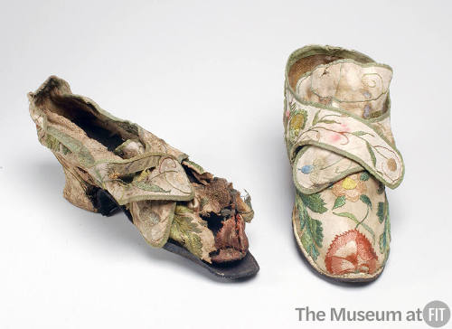 off white shoes with large, embroidered floral design with small heel. right shoe is cleaned an…