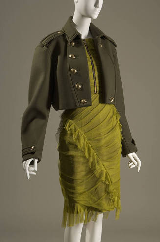 Green pleated to-the-knee zipper front dress with dark green long sleeve military style jacket …