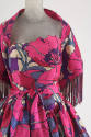 Detail view of pink, magenta and purple floral print dress showing right side of neckline outli…