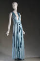 Light blue floor length halter dress with deep open V-neckline and criss-crossing ties at waist