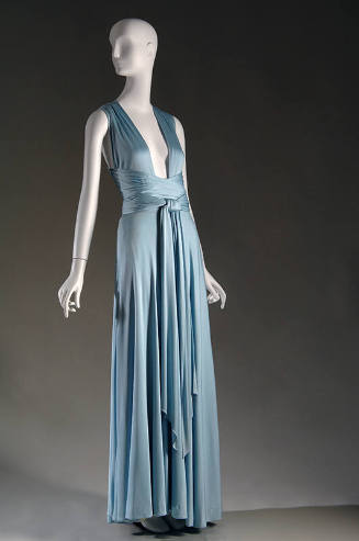 Light blue floor length halter dress with deep open V-neckline and criss-crossing ties at waist