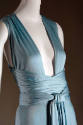 Detail view of light blue dress bodice showing deep V-neckline and ties at waist