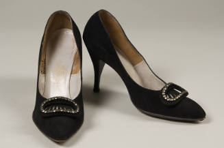 Black stiletto pumps with large oval rhinestone and faux buckle