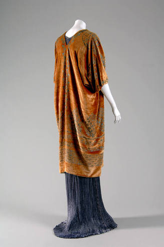 Back view of floor length light purple pleated dress with gold patterned short sleeved wrap 