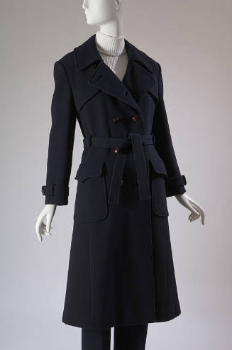 Navy blue double breasted trench coat with two flapped patch pockets, tie belt and matching pan…