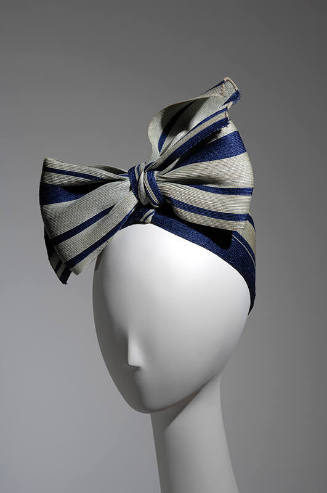 Pale green and navy blue striped turban tied in large bow
