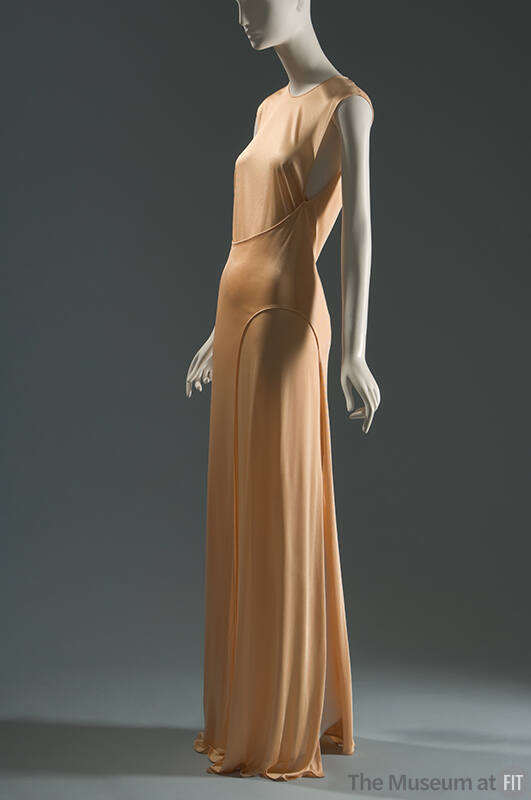 Peach sleeveless floor length evening shift dress with curved seam panel across front waist and…
