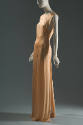 Peach sleeveless floor length evening shift dress with curved seam panel across front waist and…