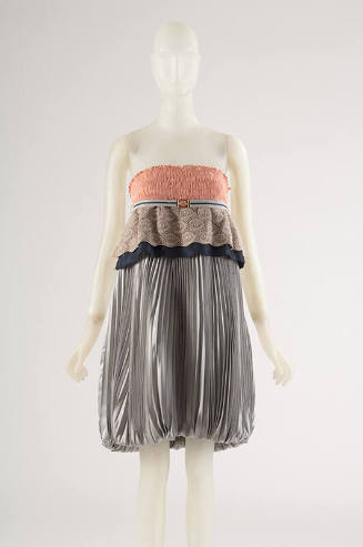 Grey pleated strapless dress with ruched orange bodice with taupe and navy lace peplum, stiped …