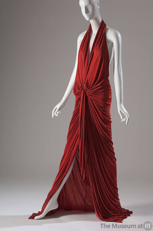 Red halter dress with deep plunge front and  floor length skirt  fully gathered at the waist 