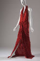 Red halter dress with deep plunge front and  floor length skirt  fully gathered at the waist 