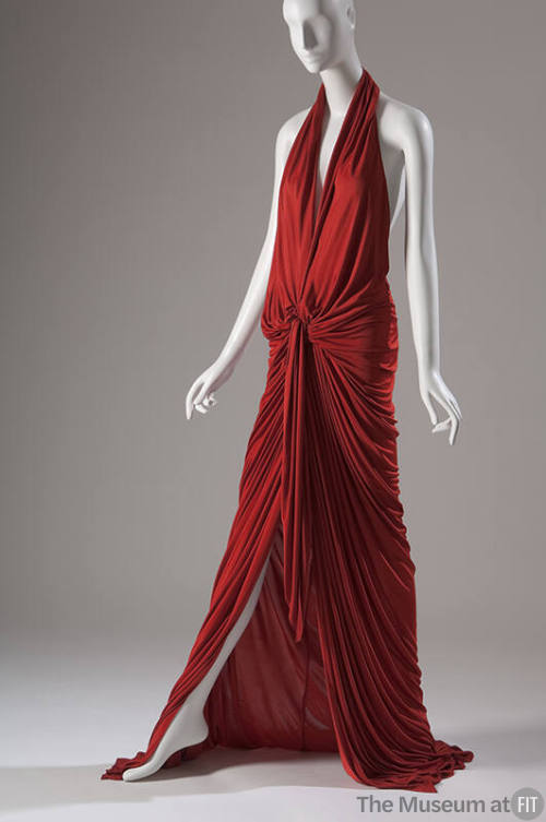 Red halter dress with deep plunge front and  floor length skirt  fully gathered at the waist 