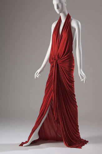 Red halter dress with deep plunge front and  floor length skirt  fully gathered at the waist 
