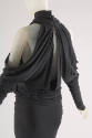 Back view of dark grey turtleneck dress with criss-cross draped back, long sleeves with  open s…